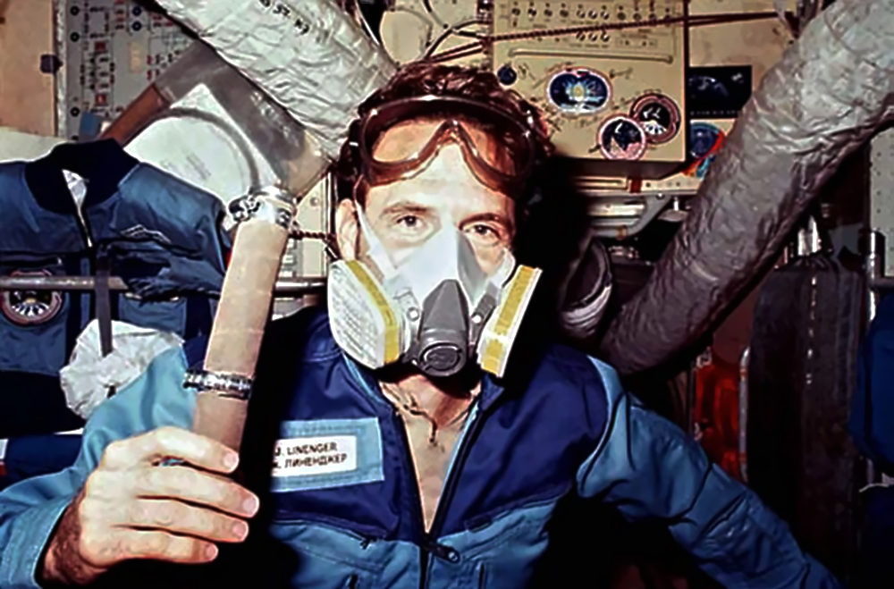Astronaut Jerry Linenger wearing a respirator mask and goggles inside the Mir space station.