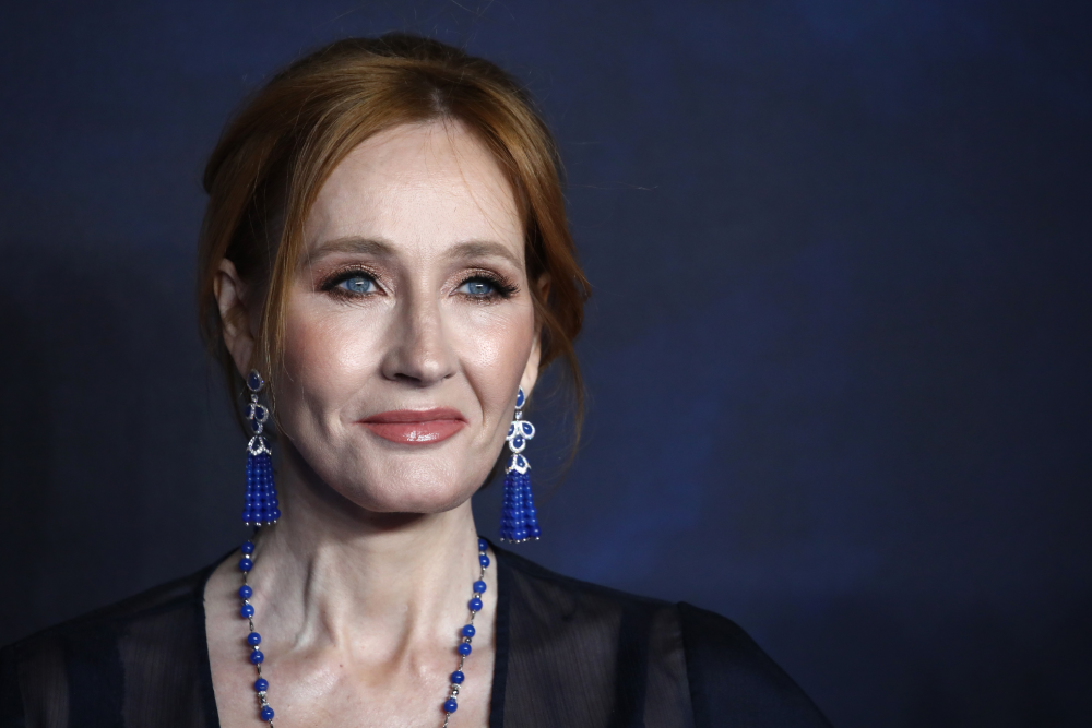 J.K. Rowling wearing blue beaded earrings and a matching necklace.