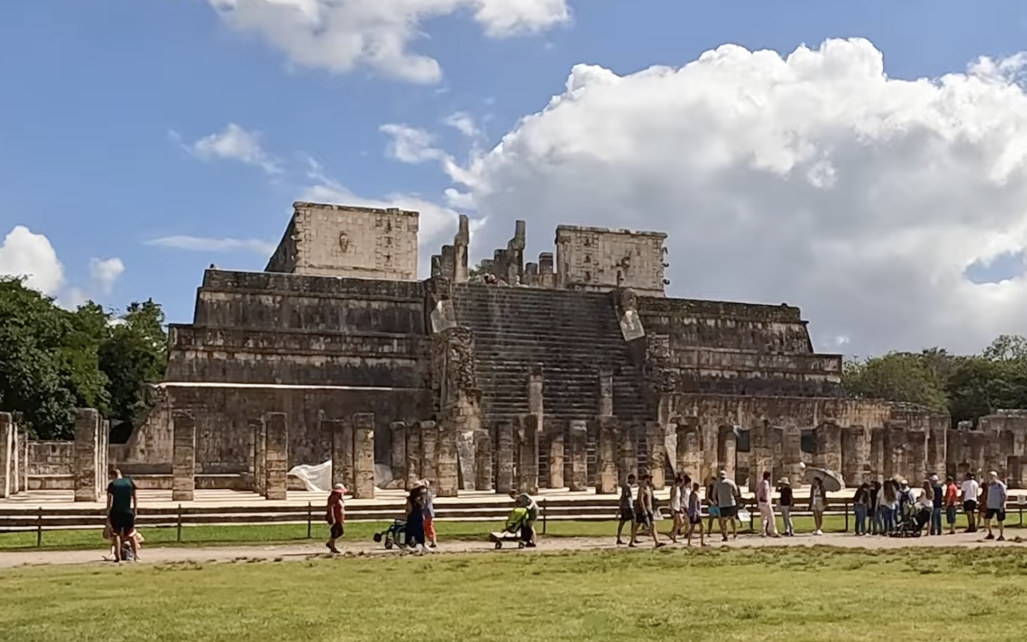 Tourists walk past the Temple of the Warriors at Chichén Itzá.