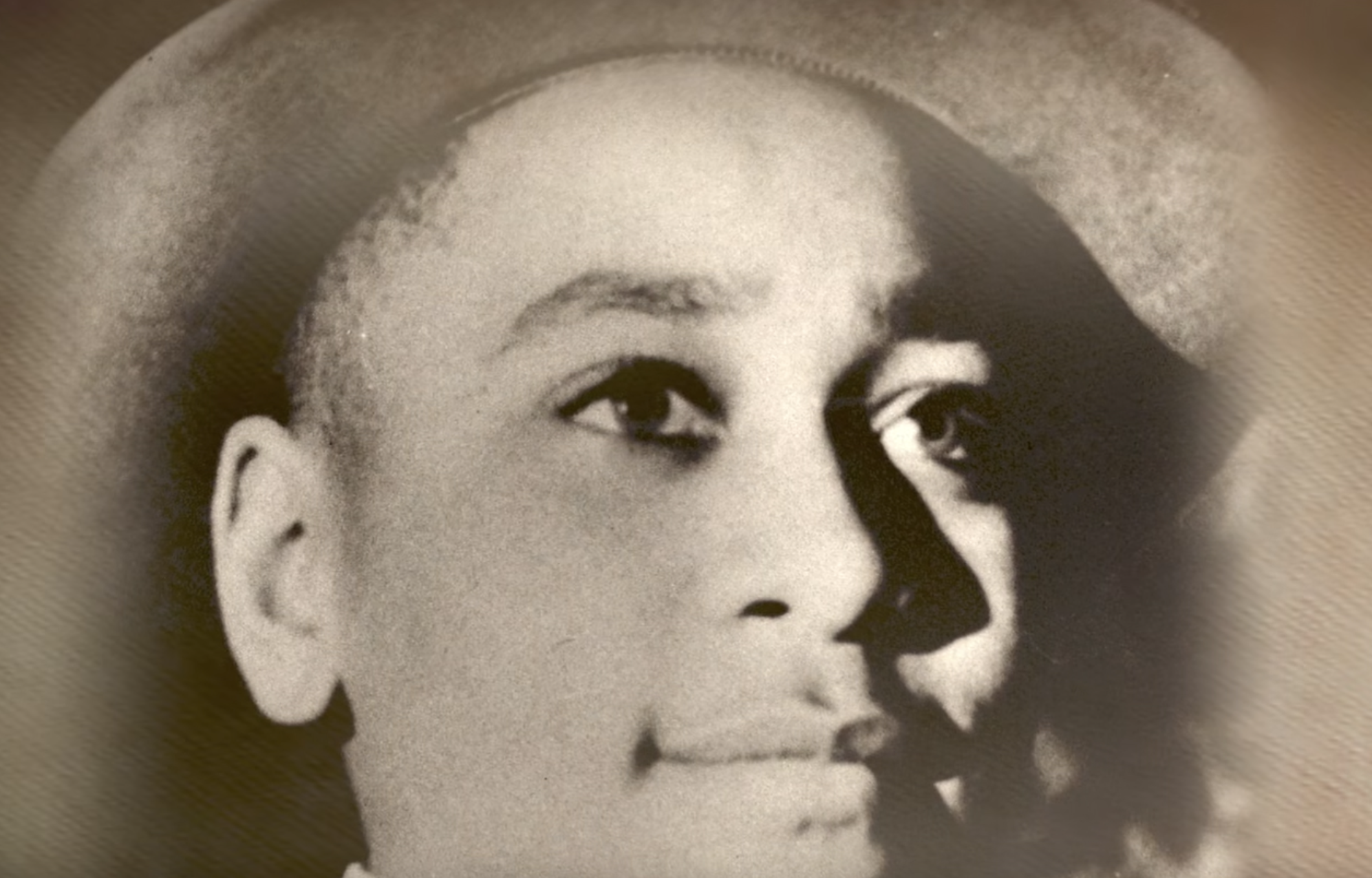 Black-and-white portrait of a young man wearing a hat.