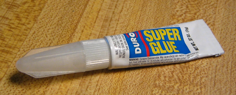 A tube of Duro Super Glue with a white plastic cap.